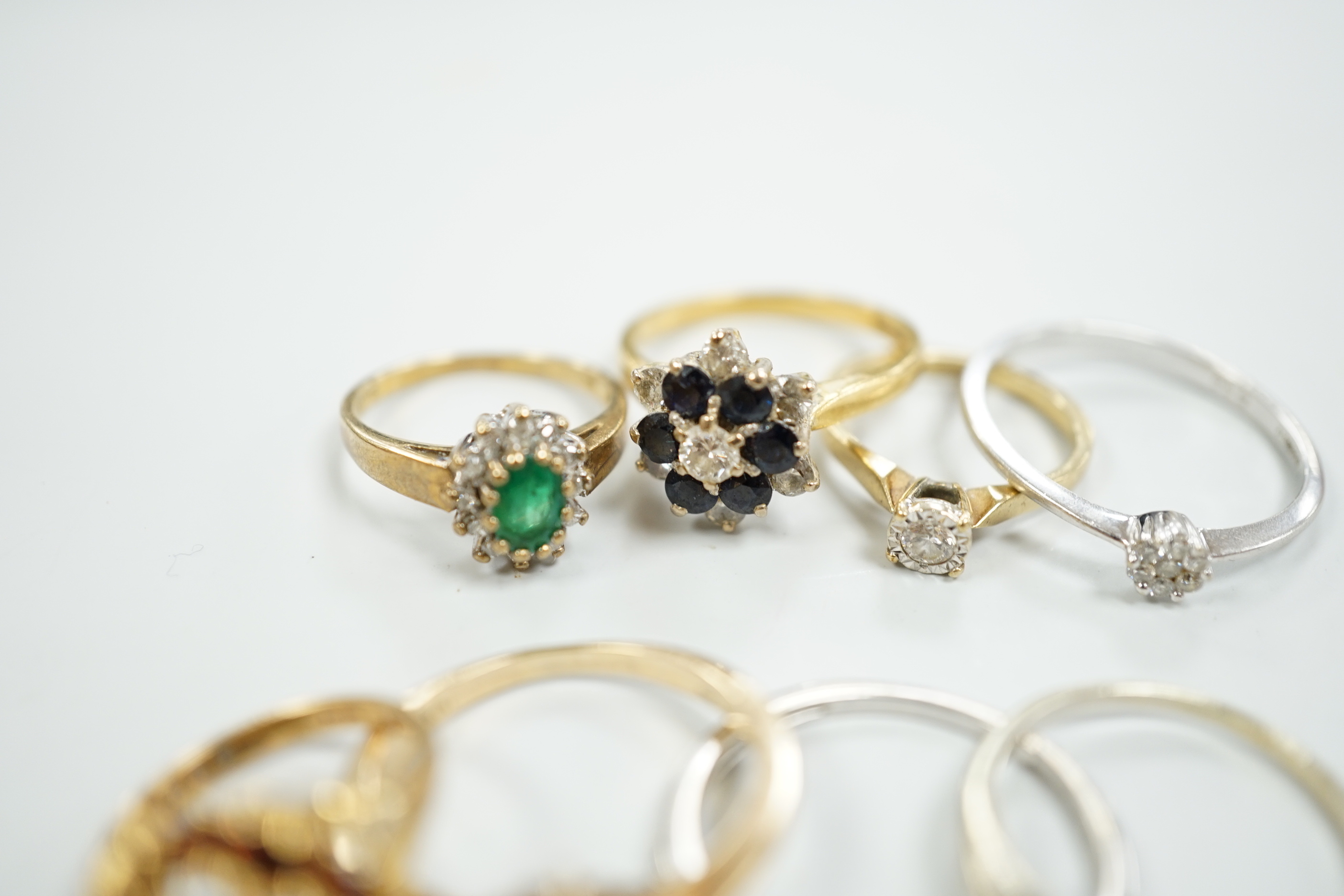 Eight assorted mainly modern 9ct gold and gem set rings, including solitaire diamond and diamond chip half eternity, gross weight 18.8 grams.